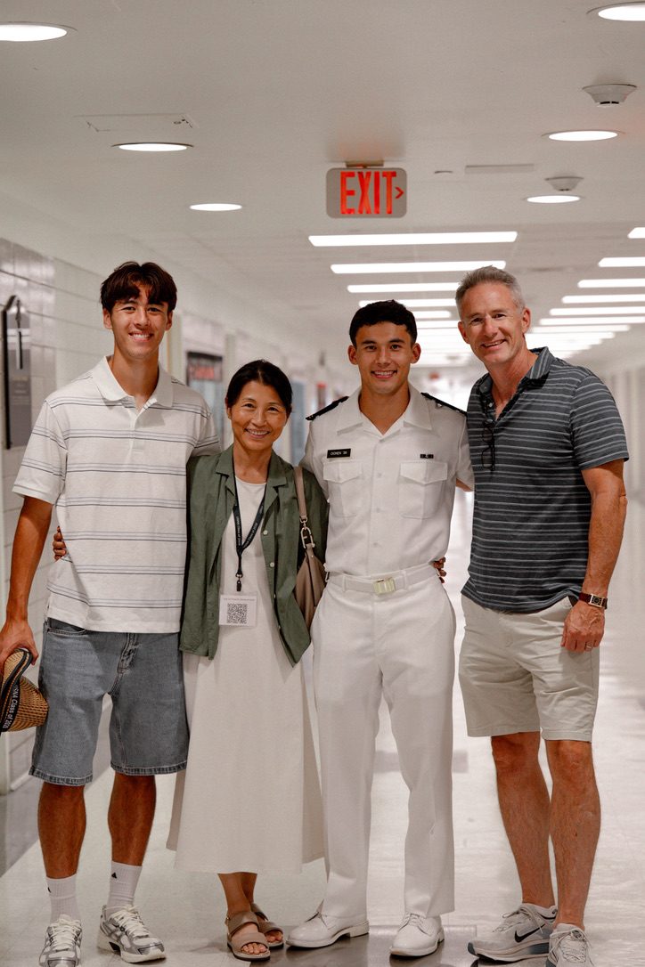 Chris Ognek with his wife and two sons; one son wears U.S. Naval Academy summer whites